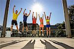 Fitness class celebrating on city rooftop