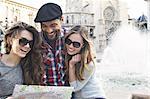 Tourist friends looking at map, Plaza de la Virgen, Valencia, Spain