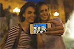 Two young women posing for self portrait, Plaza de la Virgen, Valencia, Spain