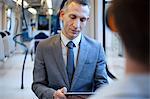 Businessman using digital tablet on train