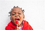 Portrait of female toddler enjoying lollipop