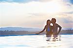 Romantic couple kissing in outdoor swimming pool