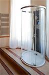 Oval shaped freestanding shower unit in modern bathroom, London