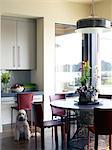 Chairs at round table in dining room of USA home