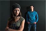 Teenage Girl and Young Man Arguing, Studio Shot