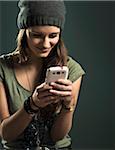 Portrait of Teenage Girl using Cell Phone, Studio Shot