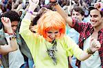 Woman in wig dancing at music festival