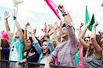 Fans cheering at music festival