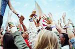 Fans reaching to shake hands with performer at music festival