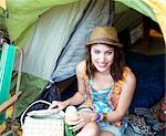 Portrait of smiling woman in tent at music festival