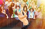 Fans cheering for performer singing on stage