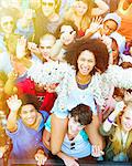 Portrait of cheering woman on man's shoulders at music festival