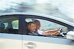 Happy senior couple driving in car