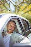Portrait of senior man laughing in car