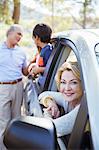 Grandparents and grandchildren inside and outside car