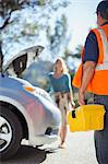 Roadside mechanic arriving to help woman