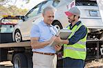 Roadside mechanic and man with paperwork