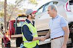 Roadside mechanic and man shaking hands