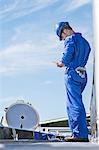 Worker using digital tablet on platform