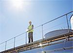 Worker on platform above milk tanker