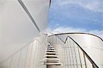 Stairs winding along stainless steel silage storage tower