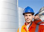 Close up portrait of worker carrying stainless steel tube