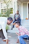 Grandfather and grandson practicing football stance