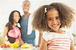 Portrait of smiling girl with parents in background