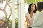 Happy mother and daughter talking on porch