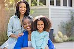 Portrait of smiling multi-generation women on patio