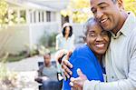 Close up portrait of happy senior couple hugging on patio