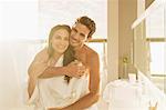 Portrait of couple hugging in bathroom