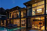 Luxury house with swimming pool illuminated at night