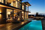 Luxury house with swimming pool illuminated at night