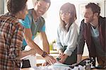 Casual business people talking in meeting at desk