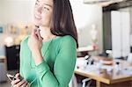 Businesswoman using hands-free device with cell phone