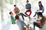 Defocused view of creative business people meeting in circle of chairs