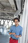 Portrait of confident casual businessman using digital tablet in office