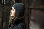 Portrait of teenage girl outdoors wearing hat, Germany