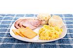 A hot, country breakfast of scrambled eggs, sliced ham, fresh, hot biscuits and sliced cheese