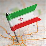 Small Flag of Islamic Republic of Iran on a Map Background with Selective Focus.