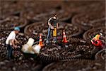 Miniature Construction Workers in Conceptual Imagery With Cookies