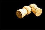 detail of two cork on black background