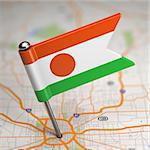 Small Flag of Niger on a Map Background with Selective Focus.