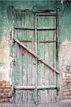 Old green door of a abandoned house