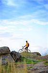 Cyclist with His Bike in the Beautiful Mountains