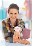 Closeup on happy seamstress showing pincushion