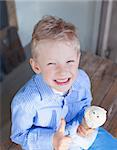 cheerful little boy eating ice-cream