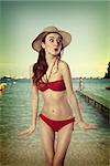 very sexy nice girl in red bikini in funny pose with a simmer hat . old fashion color