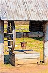 outdated wooden well with large wheel